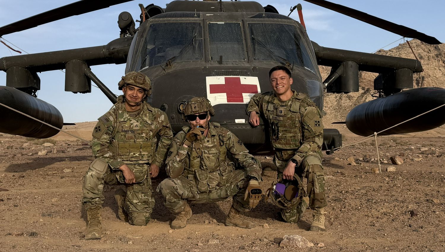 Dr. Bennett with two soldiers in front of a medevac helicopter